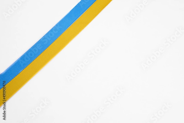 Fototapeta Ukraine flag with blue and yellow ribbons isolated on a white background. The concept of supporting Ukraine in the war with Russia