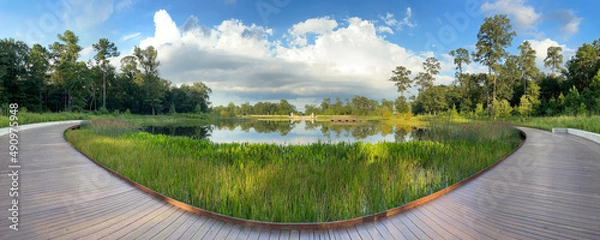 Fototapeta standing on the boardwalk overlooking the lake