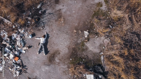 Obraz dead body the corpse of a murdered teenage girl found by drone in a garbage dump during aerial photography to search for missing people