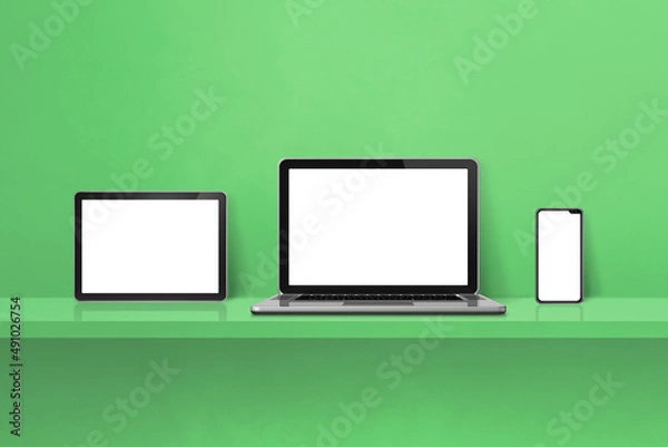 Fototapeta Laptop, mobile phone and digital tablet pc on green wall shelf. Horizontal background
