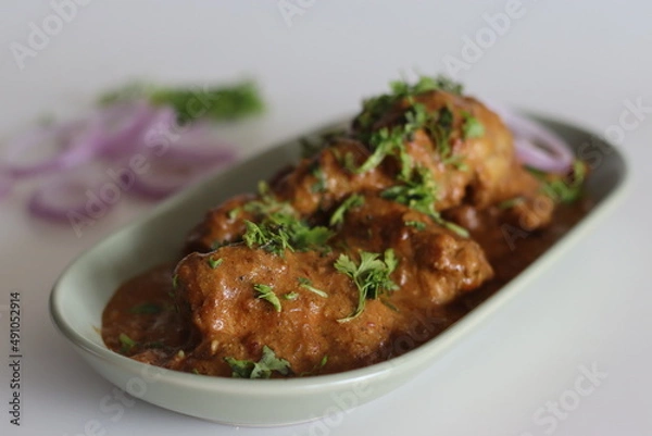Fototapeta Chicken curry prepared by chicken in cashew gravy garnished with fresh coriander leaves