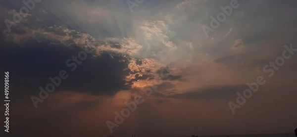 Obraz Hidden sun in dark cloud over sea