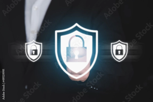 Fototapeta Businessman pressing security shield.Technology computer and internet cyber security and anti-virus concept.