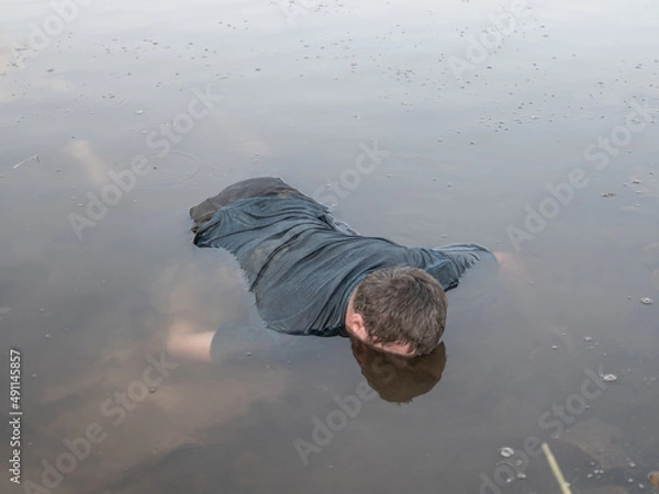 Obraz a corpse in the water, the body of a dead man was found by the lake near the pond, a drowned man was found