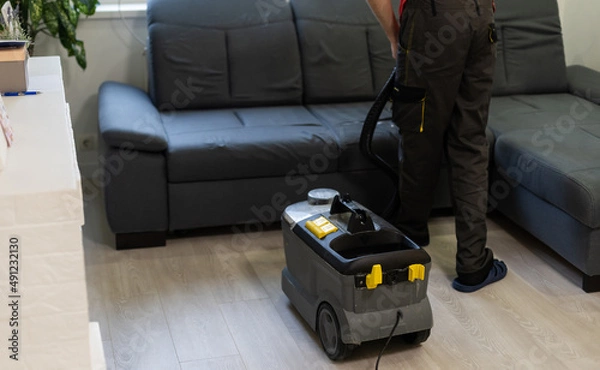 Fototapeta Removing dirt from sofa with upholstery cleaner, closeup