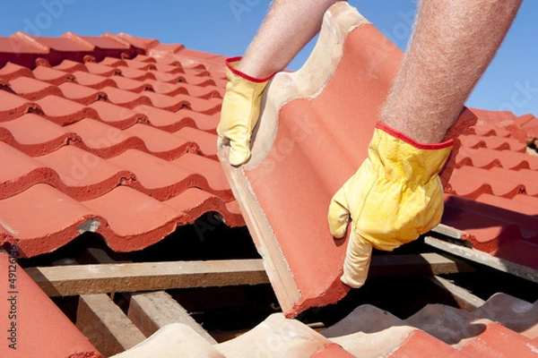 Obraz Construction worker tile roofing repairs