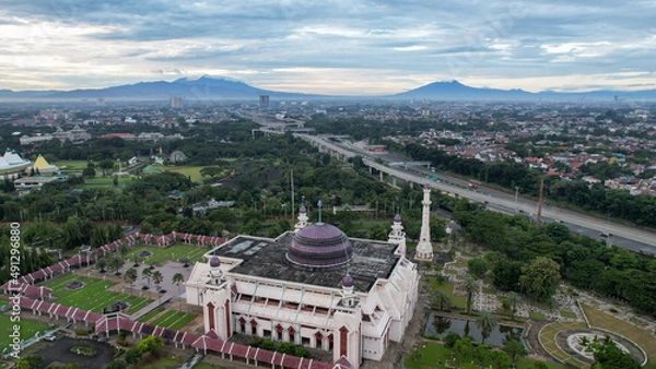 Fototapeta Aerial view of At Tin Grand Mosque, where this mosque is the largest mosque in Indonesia which is located in East Jakarta with mountain view. Jakarta, Indonesia, March 8, 2022