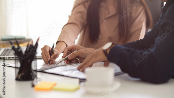 Fototapeta Male boss explaining and having meeting with his assistant