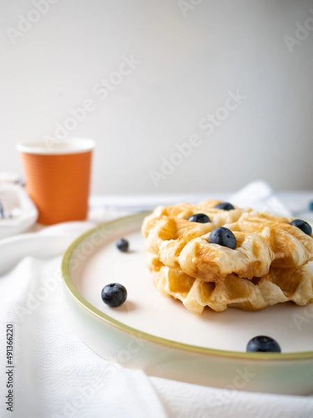 Fototapeta Delicious homemade waffle toping with blueberries