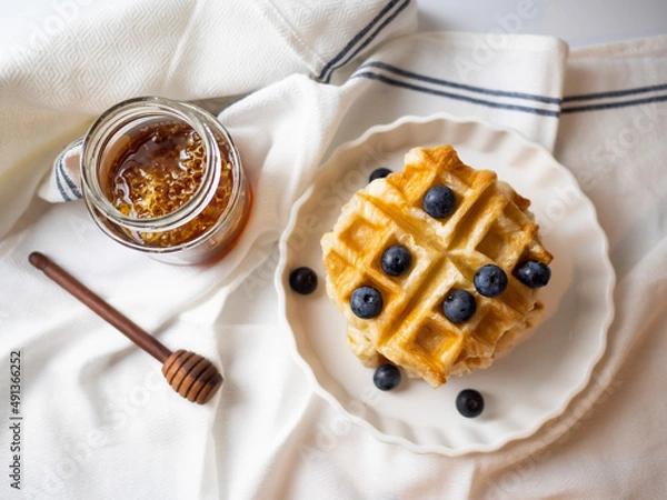 Fototapeta Delicious homemade waffle toping with blueberries