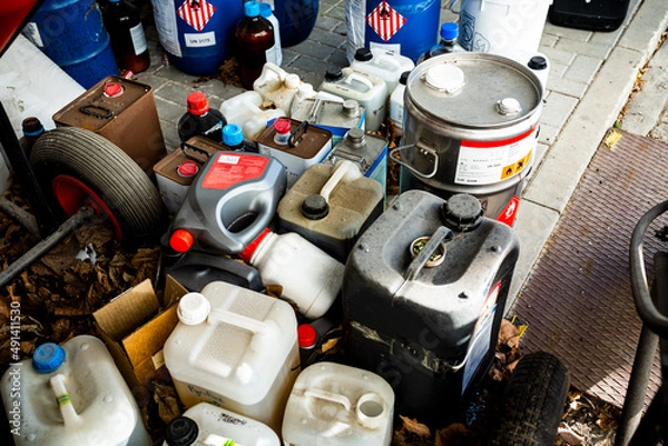 Fototapeta Metal and plastic barrels containing hazardous chemicals from industry, waste management concept, business concept