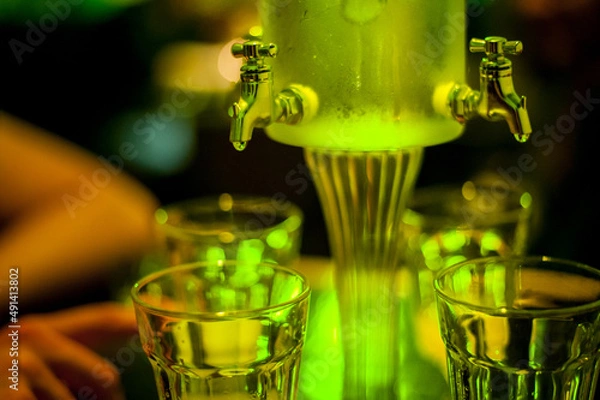 Obraz green absinthe drip fountain for a big company with four taps in a bar