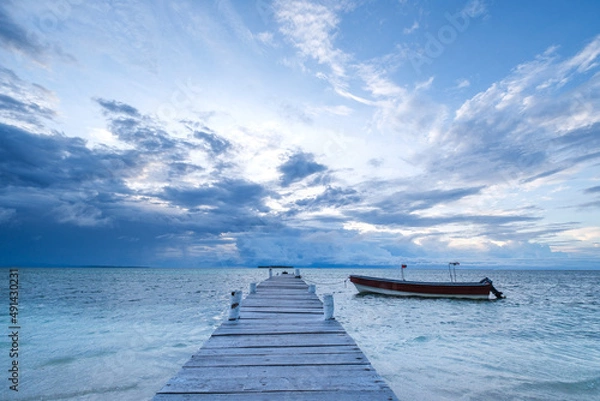 Obraz Dramatic sky over caribbean sea with small boat