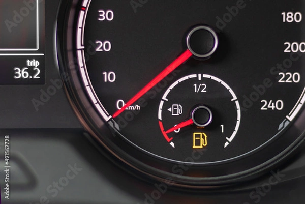 Fototapeta soft focus. natural light. the dashboard. it is lit, the fuel level arrow shows that it is empty, refueling is necessary. there is a tinting.