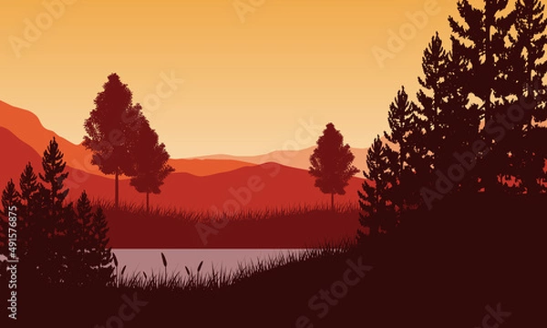 Obraz Incredible view of Mountains and lake from the edge of the grass with pine tree silhouettes all around