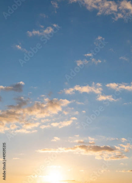 Fototapeta Clouds in the sky all the way to horizon line taken early evening just before sunset	