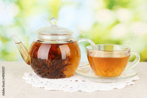 Fototapeta Exotic green tea with flowers in glass teapot