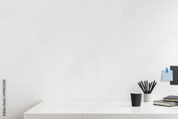 Obraz Office table, empty desk with supplies and white wall copy space.	