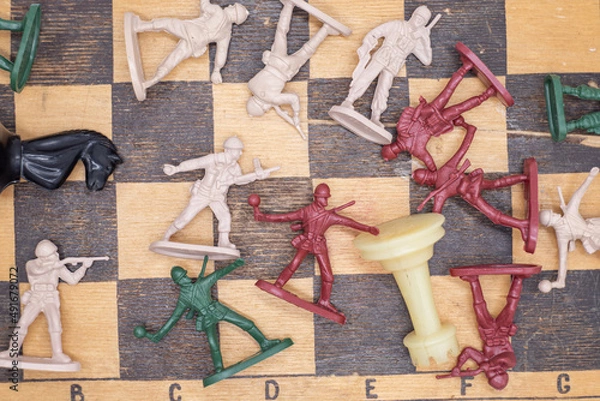 Fototapeta Photo plastic toy soldiers on a chessboard