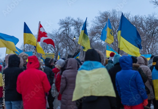 Obraz group of people on the street with Ukrainian flags at the anti-war demonstration in Regina, Saskatchewan, Canada.