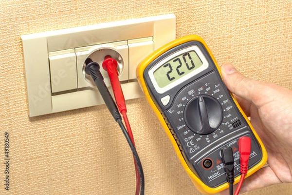 Fototapeta metering socket voltage with digital multimeter
