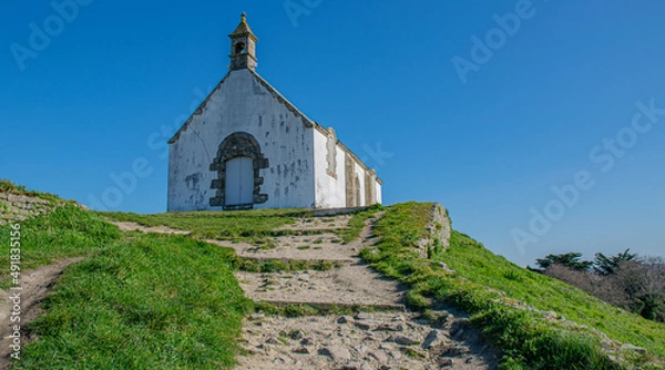 Fototapeta Carnac,France;26 February 2022:Chapelle Saint Michel on the tumulus site located in Morbihan in Brittany, the town is known for its alignments of 2,934 menhirs.