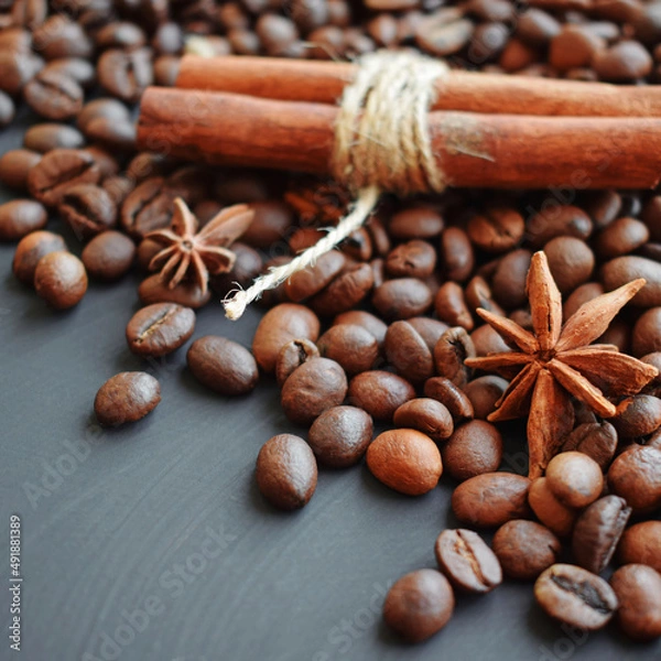 Fototapeta Coffee beans, cinnamon on a gray background.