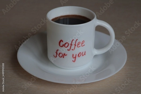 Obraz A white mug with black coffee stands on a light surface.