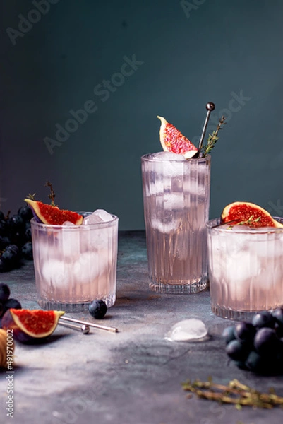Fototapeta non alcoholic beverage with ice, figs and thyme garnish