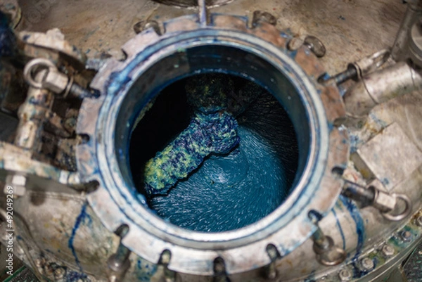 Fototapeta Lubricating grease Lithium complex NLGI 3 with blue dye in the autoclave kettle. Blue grease on the paddle with some yellow grease. Industrial and automotive concept. Manufacturing in the factory