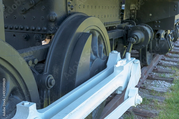 Obraz The wheels of an old steam engine on railroad tracks