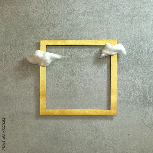 Fototapeta Fluffy clouds on a gold frame. Concrete gray background. Text space. Top view. Minimal style.