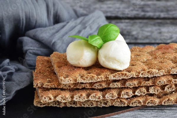 Obraz Crispy buckwheat bread with mozzarella and basil.Buckwheat cracker.Healthy eating.