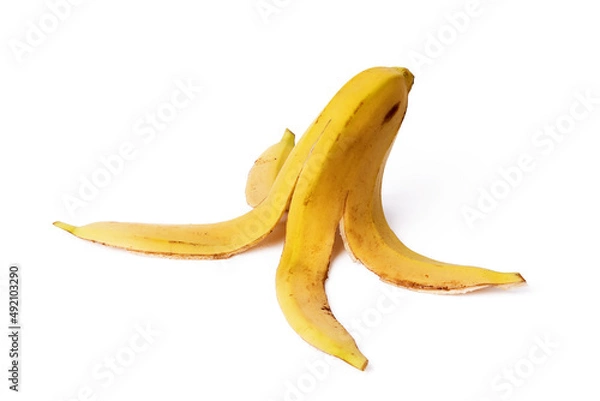 Fototapeta Close-up of a banana peel on the ground on a white background. Concept of organic waste