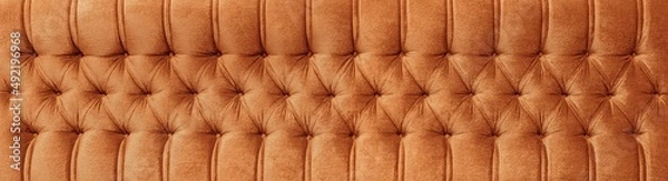Fototapeta Close up of a sofa background. Spotted furniture texture.