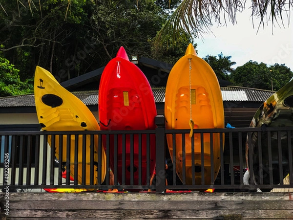 Fototapeta Redang Island Malaysia Colourful kayaks, boats and canoes stacked up and waiting to go out on the sea