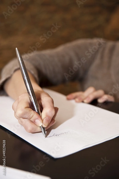 Obraz hand writing on white paper with brown background
