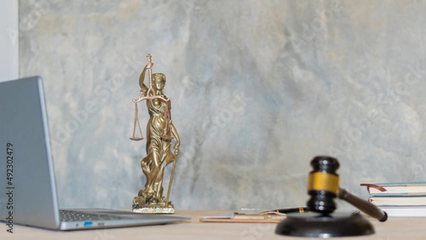 Fototapeta Justice Scales concept of judges and lawyers and a book and a wooden hammer with a laptop on the table. Justice