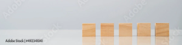Fototapeta Square wooden blocks on table , blank wooden cubes on table with copy space for text or symbols is used make to banner on wooden block