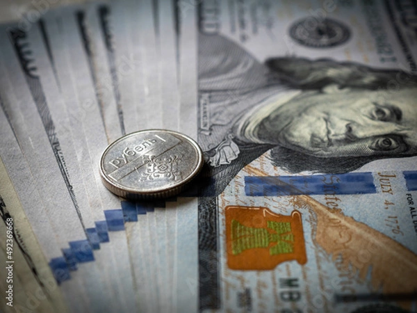 Fototapeta Belarus rouble coin on a hundred dollar bill. Belarus and USA money. Currency exchange. Economic crisis. War in Ukraine effect. Financial analytics. Investment and banking. Business 