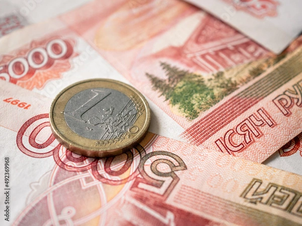 Fototapeta Euro and rouble. Foreign currency exchange. Russia and EU. Economic crisis. Russian money. Investment, business and finance. Emerging markets. Money background. Money in cash. Euro coin on roubles