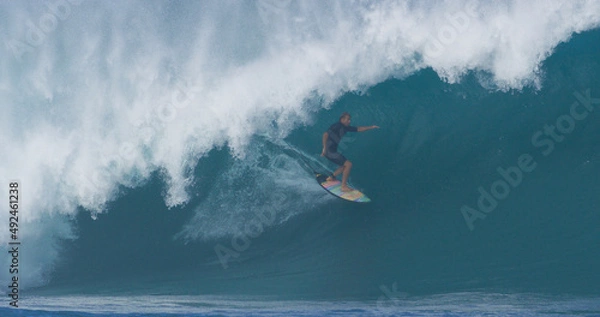 Fototapeta Surfer surfing big ocean barrel tube wave at Pipeline in north shore of Hawaii's Oahu island pro surfer Anthony Walsh