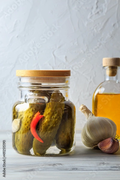 Fototapeta Pickled cucumbers in a jar.