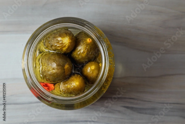 Fototapeta Pickled cucumbers in a jar.