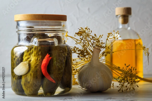 Fototapeta Pickled cucumbers in a jar.