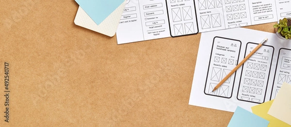 Obraz Web product design concept web banner with copy space. Top view image of a UX designer workspace with mobile app wireframe sketches. 