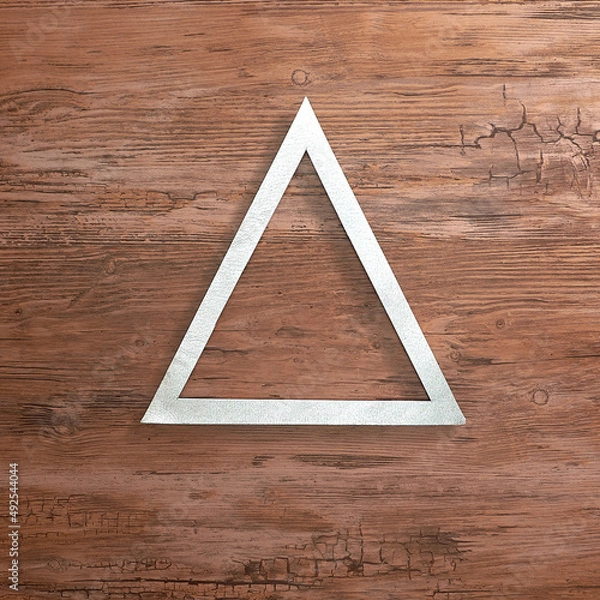 Fototapeta Silver triangular frame on a wooden background. Text space. Top view. Minimal style.