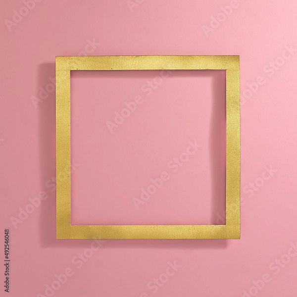Fototapeta Golden square frame on pastel pink background. Text space. Top view. Minimal style.