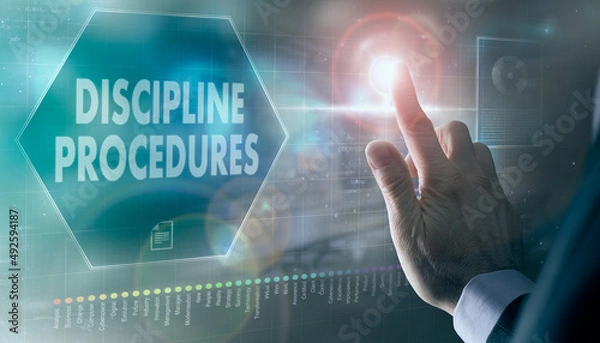 Fototapeta A businessman controlling a futuristic display with a Discipline Procedures business concept on it.