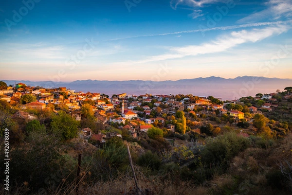 Fototapeta sunset over the mountains and village